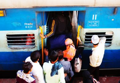 People crowd onto an Indian train, symbolising university admissions