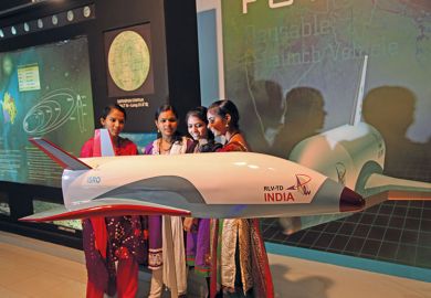 indian women next to indian space shuttle