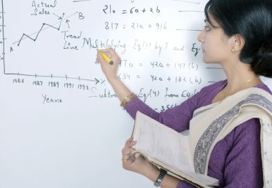 An Indian academic writes formulas on a whiteboard An Indian academic writes formulas on a whiteboard