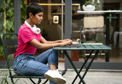 An Indian student or entrepreneur works on her laptop