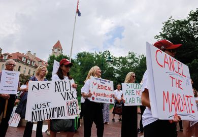 Anti-vaxxers and anti-maskers gathered at Indiana University’s Sample Gates to protest against mandatory Covid vaccinations Anti-vaxxers and anti-maskers gathered at Indiana University’s Sample Gates to protest against mandatory Covid vaccinations