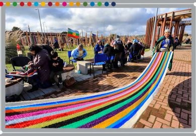 Indigenous Mapuche women weave on a loom a 1-kilomemter weave in an attempt to break a Guinness Record in Puerto Saavedra, Chile on 21 May 2022. To illustrate how universities can learn from the sustainable use of textiles in South America.