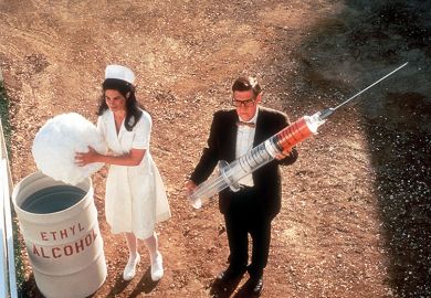 Nurse and man holding giant syringe