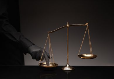 A man presses his finger on the scales of justice A man presses his finger on the scales of justice
