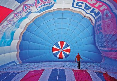Man inside a hot air balloon to suggest reversing higher education expansion in England Man inside a hot air balloon to suggest reversing higher education expansion in England