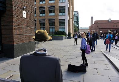 Street entertainer dressed as the Invisible Man, London, England