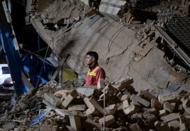 An Iranian firefighter in the ruins of a collapsed building in Tehran on March 11, 2025
