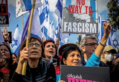 Protesters hold Israeli flags and placards while chanting slogans during the demonstration