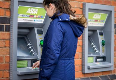 Young adult woman withdrew from cash machine.