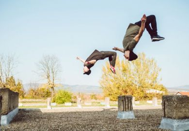 Two people perform backflips Two people perform backflips illustrating flipped classroom model