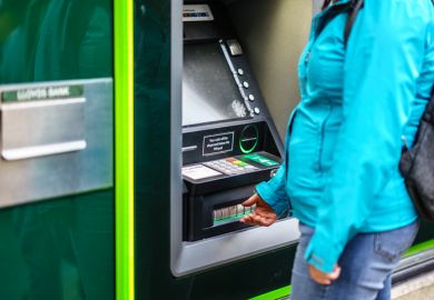 Young adult woman withdrew from cash machine.