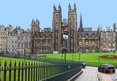The gothic spires of the University of Edinburgh on a hillside leading to the Old Town district.