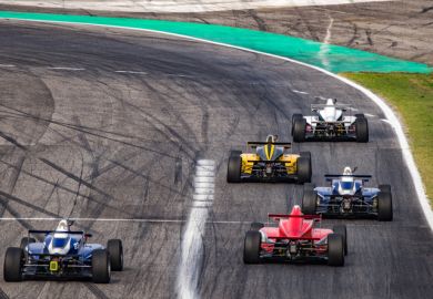 Cars racing on track