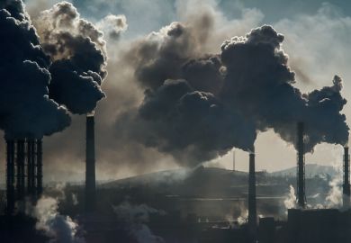 Black smoke rises from chimneys on industrial plant