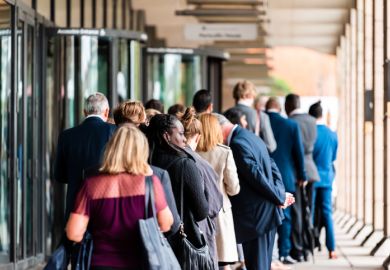People many crowd crowded standing in line queue to Westminster station