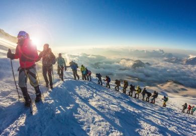  Group of people climbs the mountain Elbrus. Every year thousands of people climb the highest mountain in Russia and Europe.