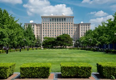 Green gardens and the main Building of the famous Tsinghua University in Beijing, China.