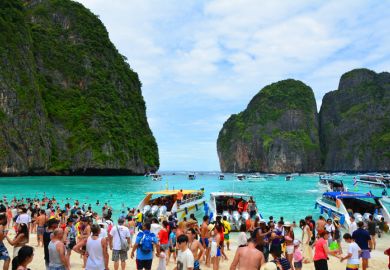 Famous crowded beautiful beach in Maya Bay. Maya Bay is closed due to damage to the coral reef by boats and intense tourism.