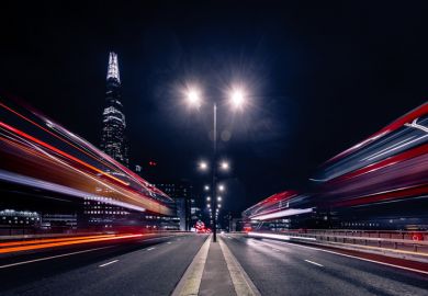 Blurred cars speed down a city street at night Blurred cars speed down a city street at night