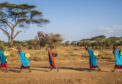 Maasai women carrying water