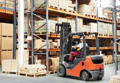 warehouse worker in uniform loading boxes by forklift to show lift and shift in transnational education
