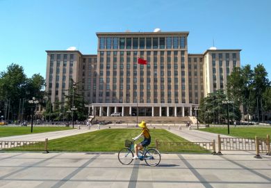 Students biking in front of the main entrance of Tsinghua University in Beijing, China. Students biking in front of the main entrance of Tsinghua University in Beijing, China.