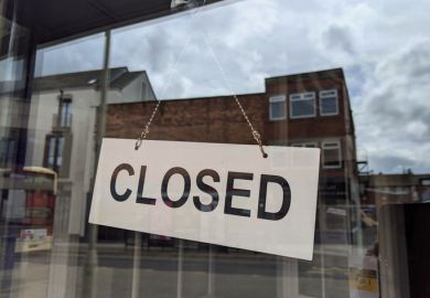 A closed sign hanging in a shop window A closed sign hanging in a shop window