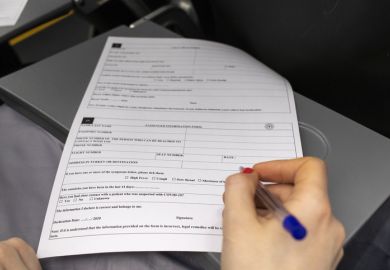 A woman on board a plane fills out a passenger information form.
