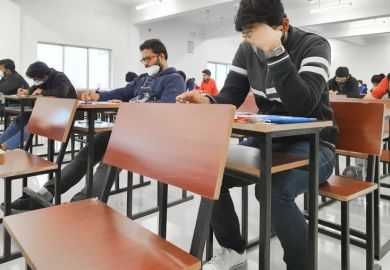 Medical students writing examination paper in mask maintaining social distancing at Radheshwam Medical College,Lucknow, UP, India.