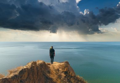A man stands on the edge of a cliff A man stands on the edge of a cliff