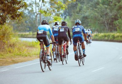 Group of cyclists chases another in a race