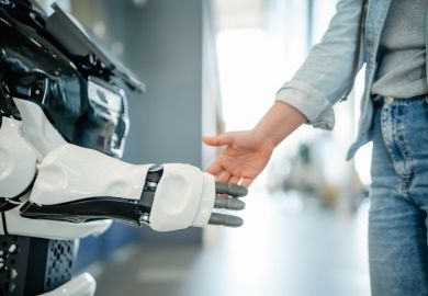 A man shakes hands with a robot A man shakes hands with a robot