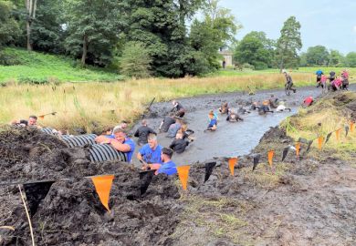 Participants in a 'Tough Mudder' event Participants in a 'Tough Mudder' event