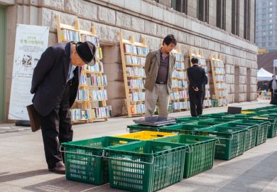 A street side book market outside Seoul City Hall near Seoul Plaza on a sunny afternoon in Seoul, South Korea.