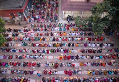 Thousands of Hindu devotees sits with Prodip and prays to God in front of Shri Shri Lokanath Brahmachari Ashram temple.