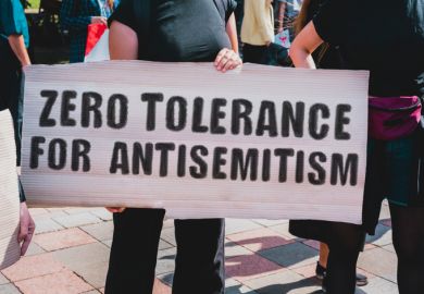Protesters with a sign saying "Zero tolerance for antiseme=itism" Protesters with a sign saying "Zero tolerance for antisemitism"