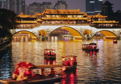  Stream of little tour boats on the Jinjiang River at night, passing the Anshun Bridge, in Chengdu, Sichuan, China