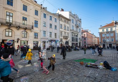 Children playing on a cobblestone street in Ukraine's Lviv