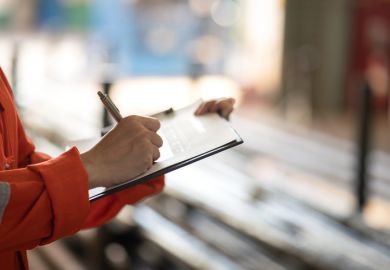 Writing on safety checklist document during safety audit and inspection. Writing on safety checklist document during safety audit and inspection.