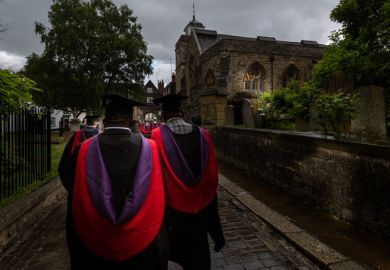 Canterbury Christchurch BAME Graduates process along wet Rochester streets in the rain following the graduation ceremony.