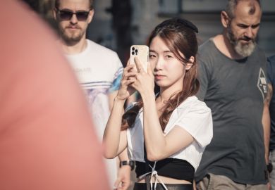 Happy smiling tourists strolling and taking pictures on the famous Charles Bridge in Prague. Happy smiling tourists strolling and taking pictures on the famous Charles Bridge in Prague.