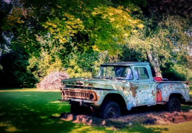 An old pickup truck, in disrepair, sits on the roadside near Manitowoc, Wisconsin
