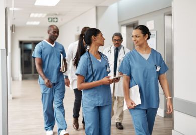 Doctors walking through hospital wearing scrubs