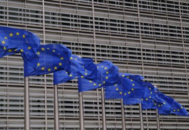 Blue flags flap in the wind outside EU headquarters Blue flags flap in the wind outside EU headquarters