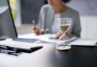 Hourglass on desk running out