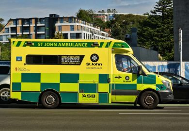 St John ambulance in traffic with driver