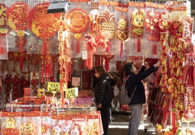To celebrate the coming Chinese New Year outdoor shopping stalls place red goods representing luck for sale.