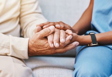 Close-up of carer holding hands with someone Close-up of carer holding hands with someone
