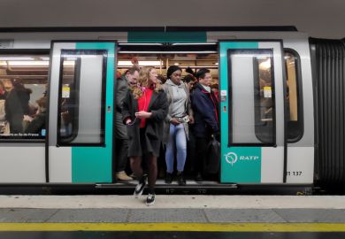Commuters in a crowded metro train in the Paris metro.
