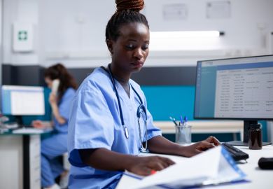 A nurse attends to some paperwork